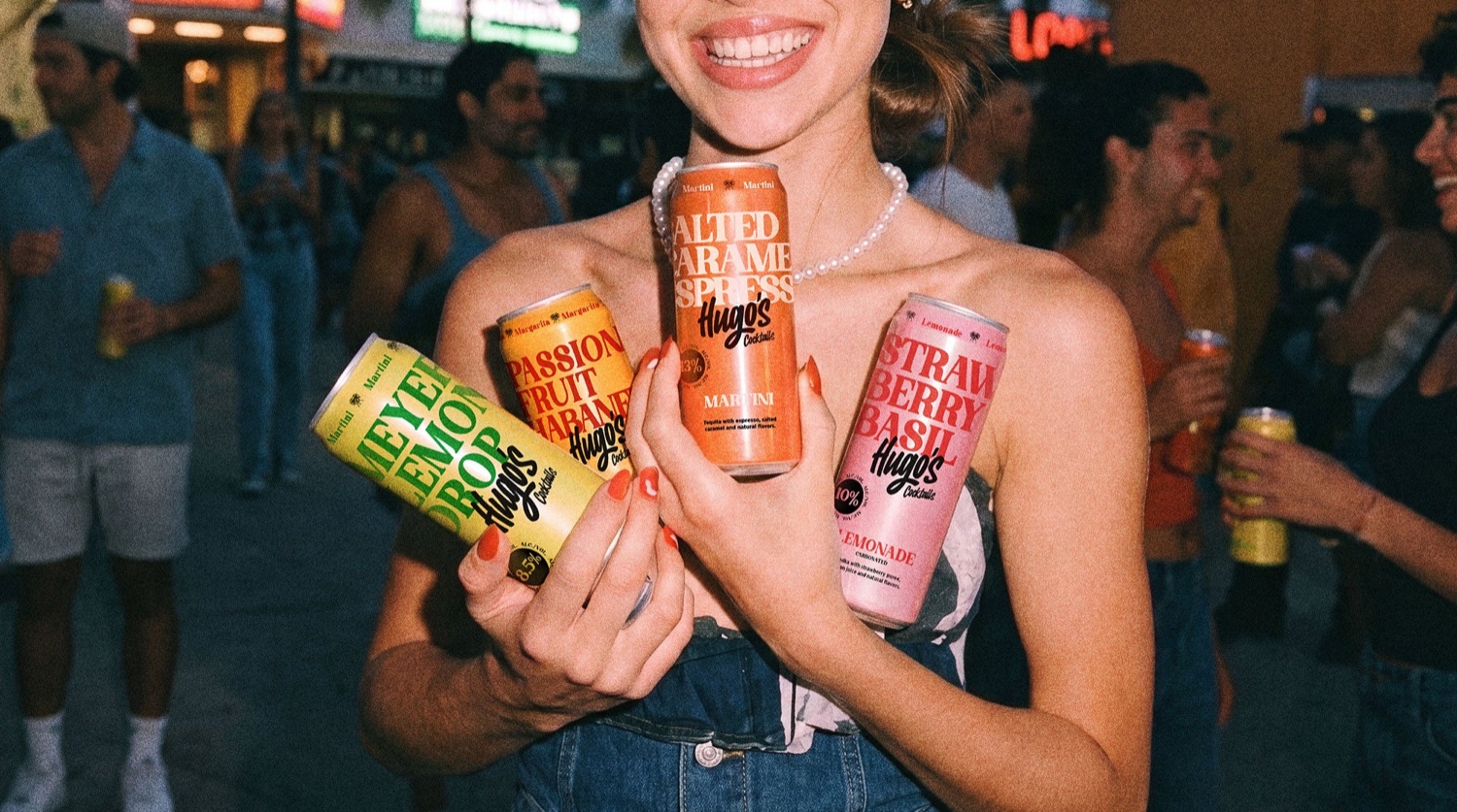 Hugo’s Cocktails cans shown at an event